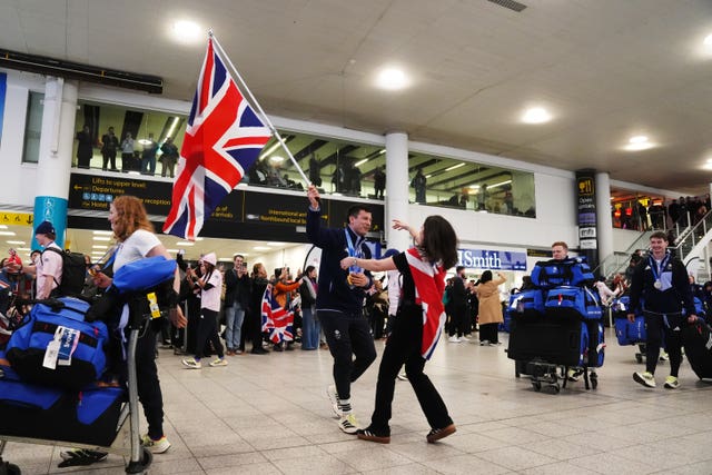 Matt Weston hugs his fiancee Alex Howard-Jones during the Team GB Homecoming at Gatwick airport