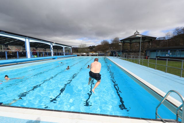 A man jumps in the pool at Hathersage outdoor swimming pool 