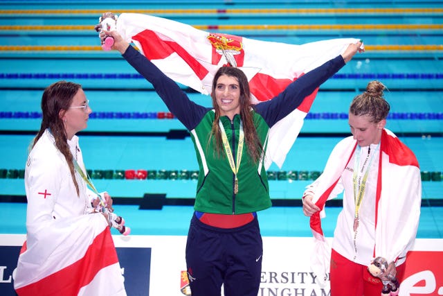 Bethany Firth, centre, claimed Northern Ireland's first ever gold medal in the pool (Peter Byrne/PA)