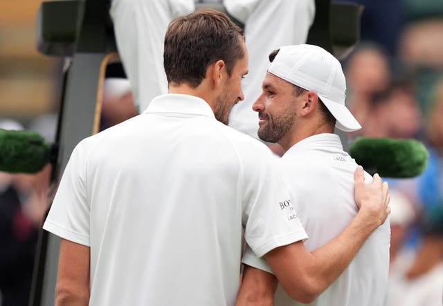 Daniil Medvedev, left, puts his arm around Grigor Dimitrov