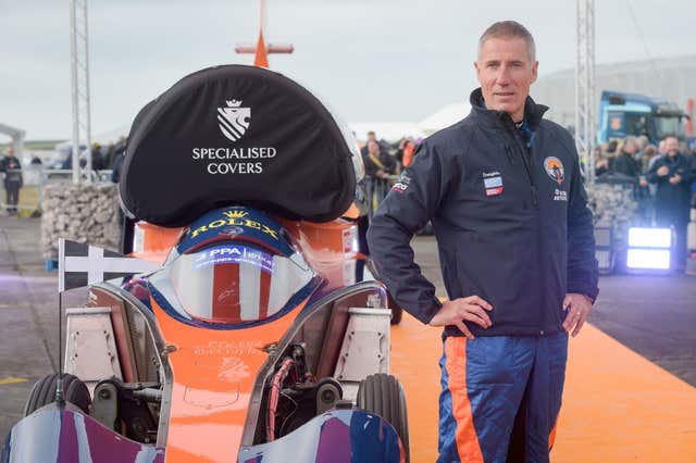 Pilot Andy Green stands beside the Bloodhound 1,000mph supersonic racing car before its first public run at Cornwall Airport, near Newquay (Ben Birchall/PA)