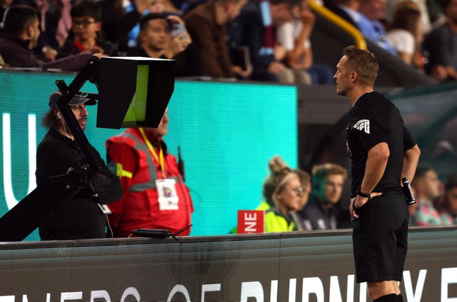 Referee Craig Pawson checks VAR