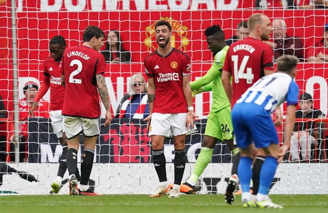 Manchester United’s Bruno Fernandes, centre, reacts after Brighton almost score against Manchester United