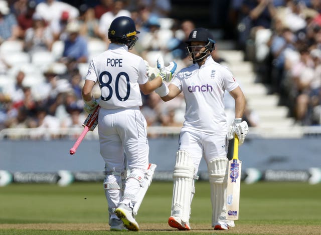 England’s Ben Duckett, right, celebrates his half-century with batting partner Ollie Pope