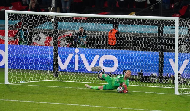 Denmark goalkeeper Kasper Schmeichel saves a penalty from England’s Harry Kane during the Euro 2020 semi final