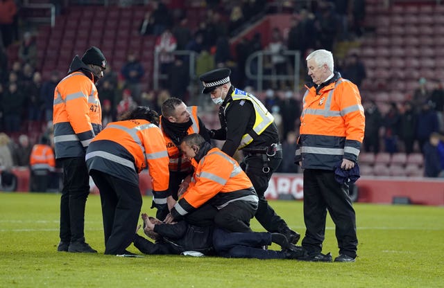 A pitch invader is stopped in his tracks 