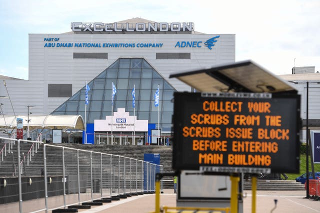 Signage advising NHS workers where to collect scrubs from at the NHS Nightingale Hospital at the ExCel centre in London (Kirsty O'Connor/PA)