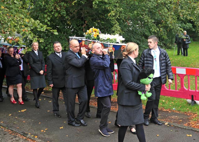 The coffins are carried into St Paul’s Church