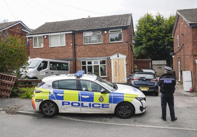 A police car and an officer outside the house