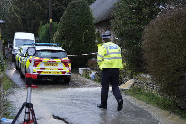 Police cars and officer outside a house in Cheriton