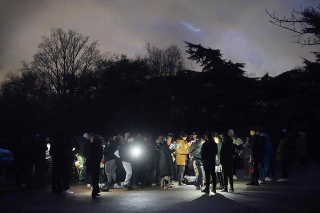 People take part in a vigil in Downhills Park in the West Green area of Haringey, London, for 16-year-old Harry Pitman. 
