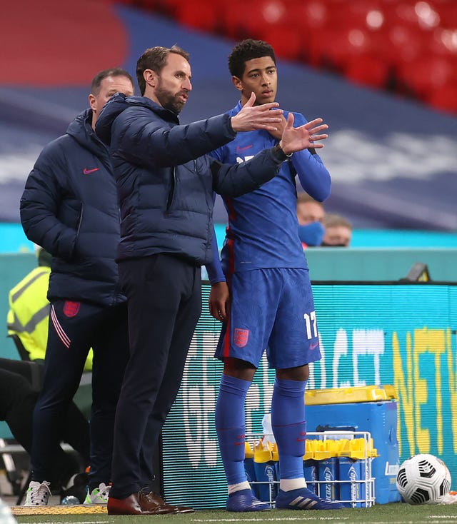 England manager Gareth Southgate gives Jude Bellingham some last minute instructions