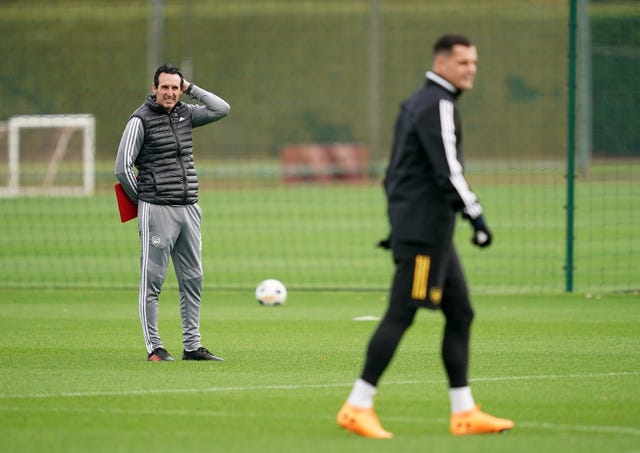 Unai Emery, left, watches over Granit Xhaka in training