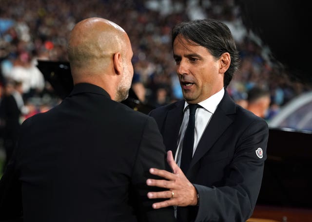 Inter Milan manager Simone Inzaghi, right, embraces Pep Guardiola