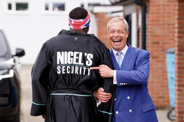 Reform UK leader Nigel Farage (right) and boxer Derek Chisora outside a boxing gym in Clacton, Essex, while on the General Election campaign trail 