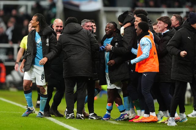 Manchester City manager Pep Guardiola, second left, and his players celebrate their second goal scored by Rayan Cherki, not pictured
