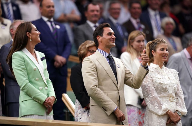 Roger Federer gives the thumbs up to Andy Murray following his victory