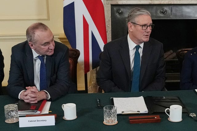 Sir Chris Wormald sitting next to Sir Keir Starmer at the Cabinet table