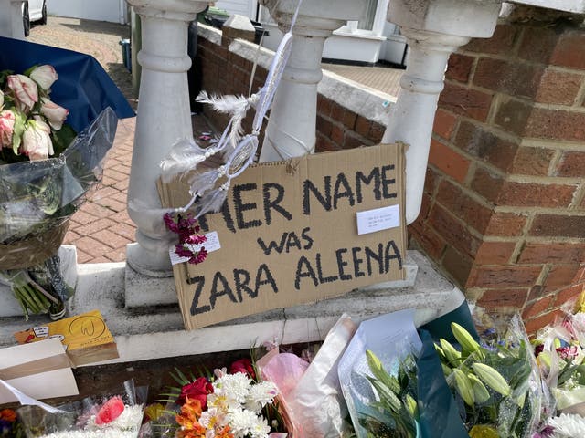 Flowers left at the site of Zara Aleena's death, a sign reads 'her name was Zara Aleena'