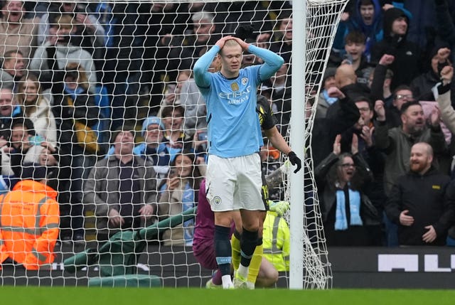 Erling Haaland puts his hands on his head in frustration after having a penalty saved against Everton