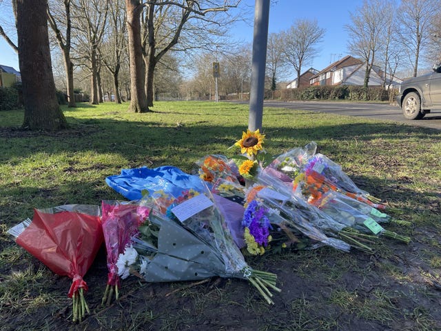 Flowers left near to the scene of a collision where two children died in Pitsea, Essex.