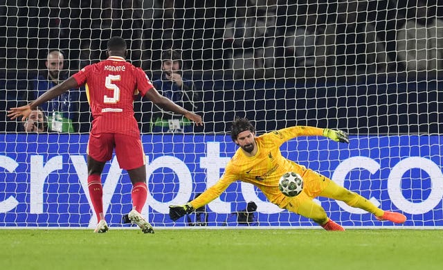 Alisson Becker (right) makes a save 