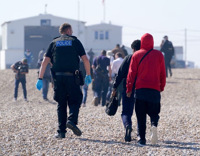 A group of people thought to be migrants are brought ashore from the Dungeness lifeboat in Kent