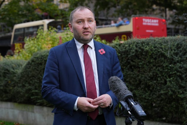 Ian Murray speaking into microphones