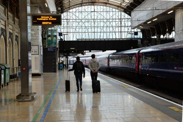 Passengers wait on a near-empty platform during a rail strike