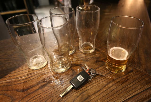 Beer glasses and a set of car keys on a bar (Philip Toscano/PA)