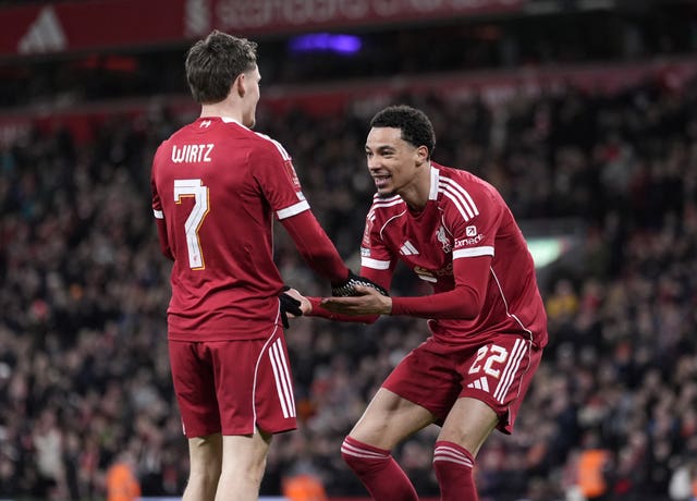 Hugo Ekitike, right, celebrate with Florian Wirtz