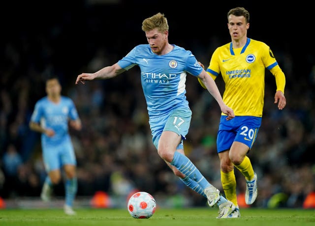 Manchester City’s Kevin De Bruyne battles with Brighton and Hove Albion’s Solly March during the Premier League match at the Etihad Stadium, Manchester. Picture date: Wednesday April 20, 2022