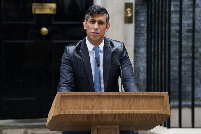 Rishi Sunak speaking at a lectern outside Number 10, in the rain