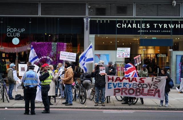 People at a counter-protest to the pro-Palestine marches, in Victoria, central London. 