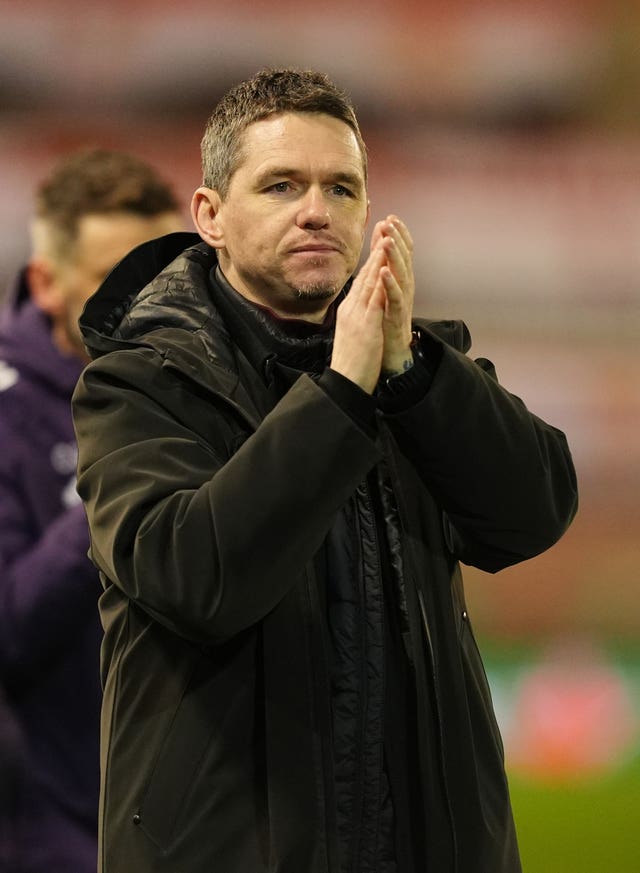 Manchester United manager Marc Skinner applauds supporters