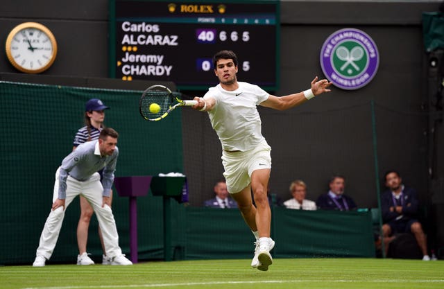 Carlos Alcaraz hits a forehand on his way to victory