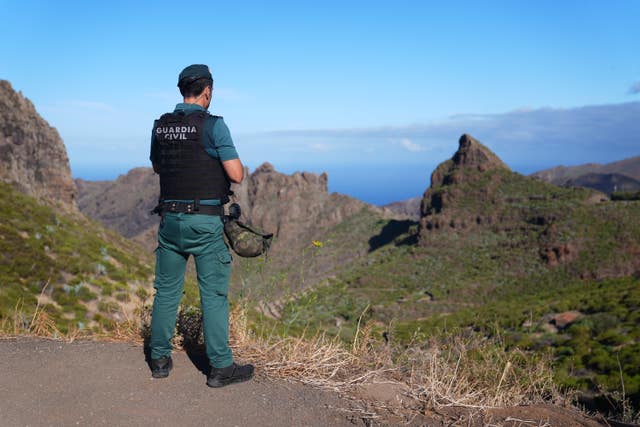 A police officer looks over terrain near Masca, Tenerife 