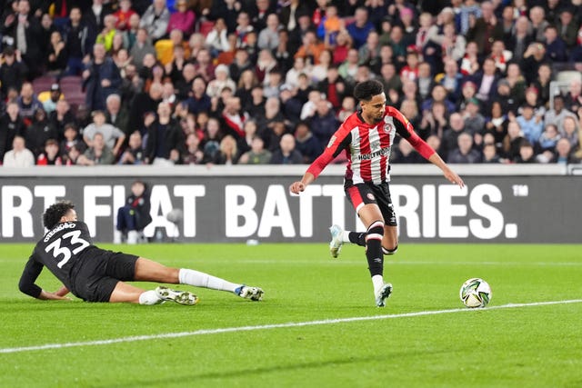 Kevin Schade, right, steadies himself to score Brentford's opener