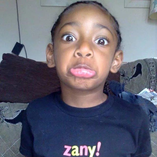 Ella Kissi-Debrah pulling a funny face ad wearing a blue T-shirt with the word Zany! on it