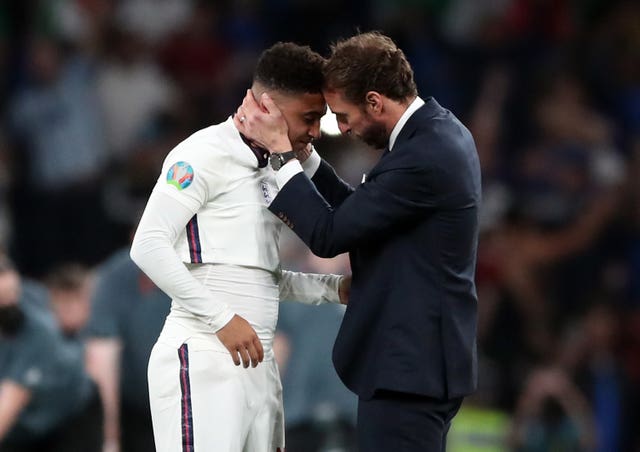 England manager Gareth Southgate consoles Jadon Sancho following defeat in the penalty shoot-out that decided Euro 2020 