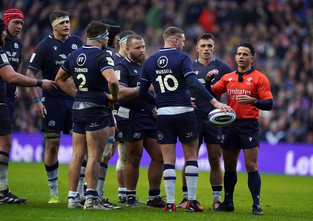 Referee Nic Berry explains his decision to Scotland's players (Andrew Milligan/PA)