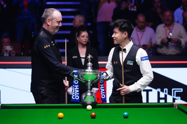 Mark Williams and Zhao Xintong pose with the trophy prior to the Final on day sixteen of the Halo World Snooker Championship at the Crucible Theatre.