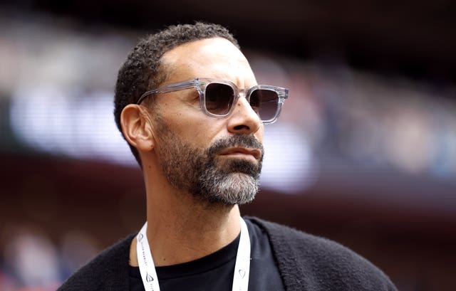 Rio Ferdinand wearing sunglasses at a football stadium