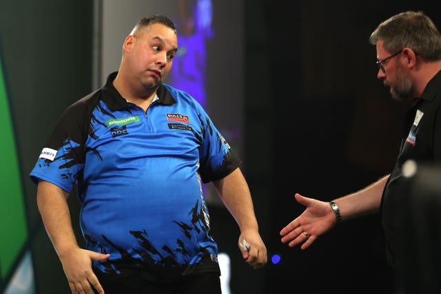 Jermaine Wattimena (left) celebrates victory against James Wade (right) at the World Darts Championship