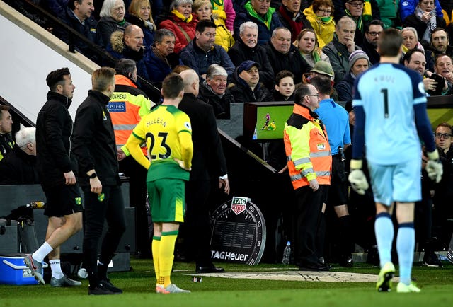 Match referee Paul Tierney consults the pitchside monitor before changing Ben Godfrey's card from a yellow to a red