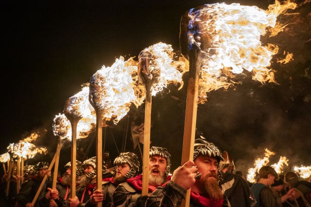 Members of the Jarl Squad take part in the torchlight procession