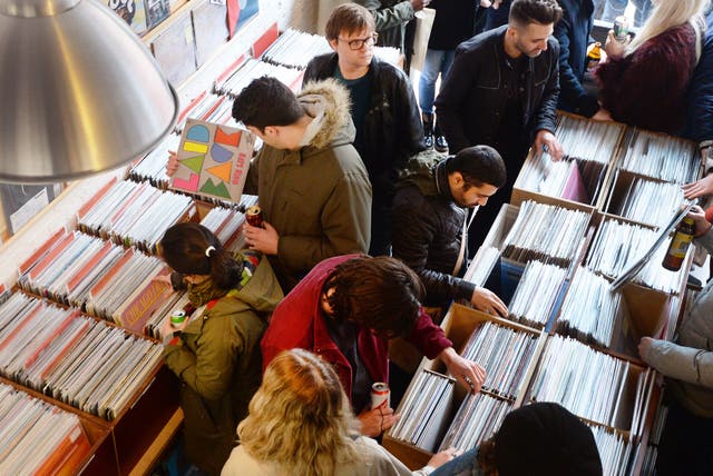 Shoppers look at vinyl records 