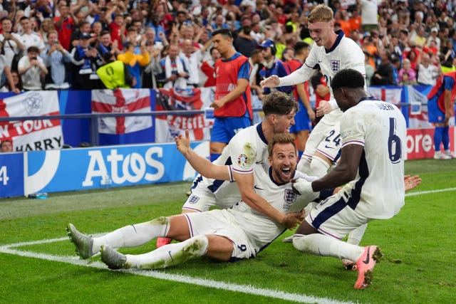 Harry Kane, centre, celebrates with team-mates, from left, John Stones, Cole Palmer and Marc Guehi after scoring England’s winner against Slovakia