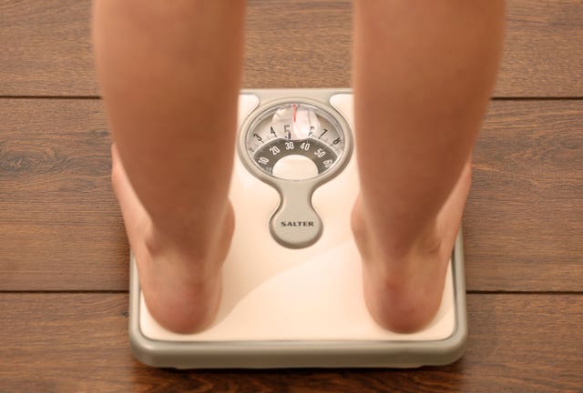 Someone using a set of weighing scales