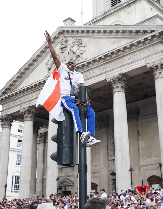 One fan climbed a traffic light in Trafalgar Square as the atmosphere ramped up (Andrew Matthews/PA)